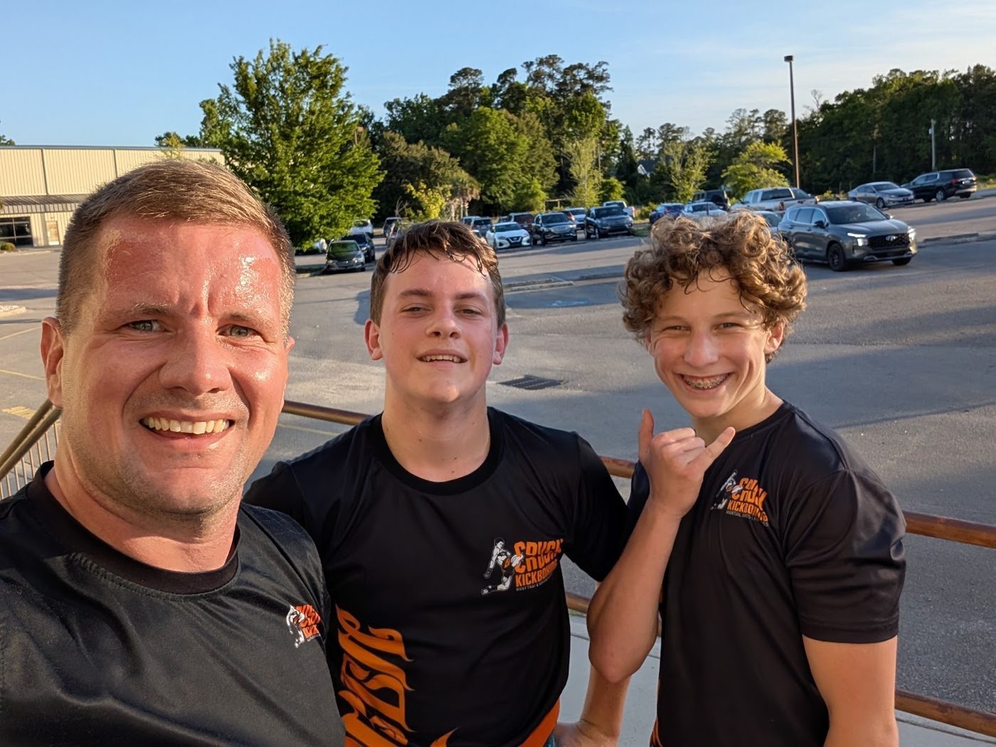 Coach Mike Reed, owner and head coach at Crush Kickboxing in Little River, SC, with students Saxon and Dakota